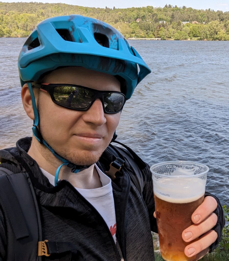 The founder of Exceptionally Average holding a beer