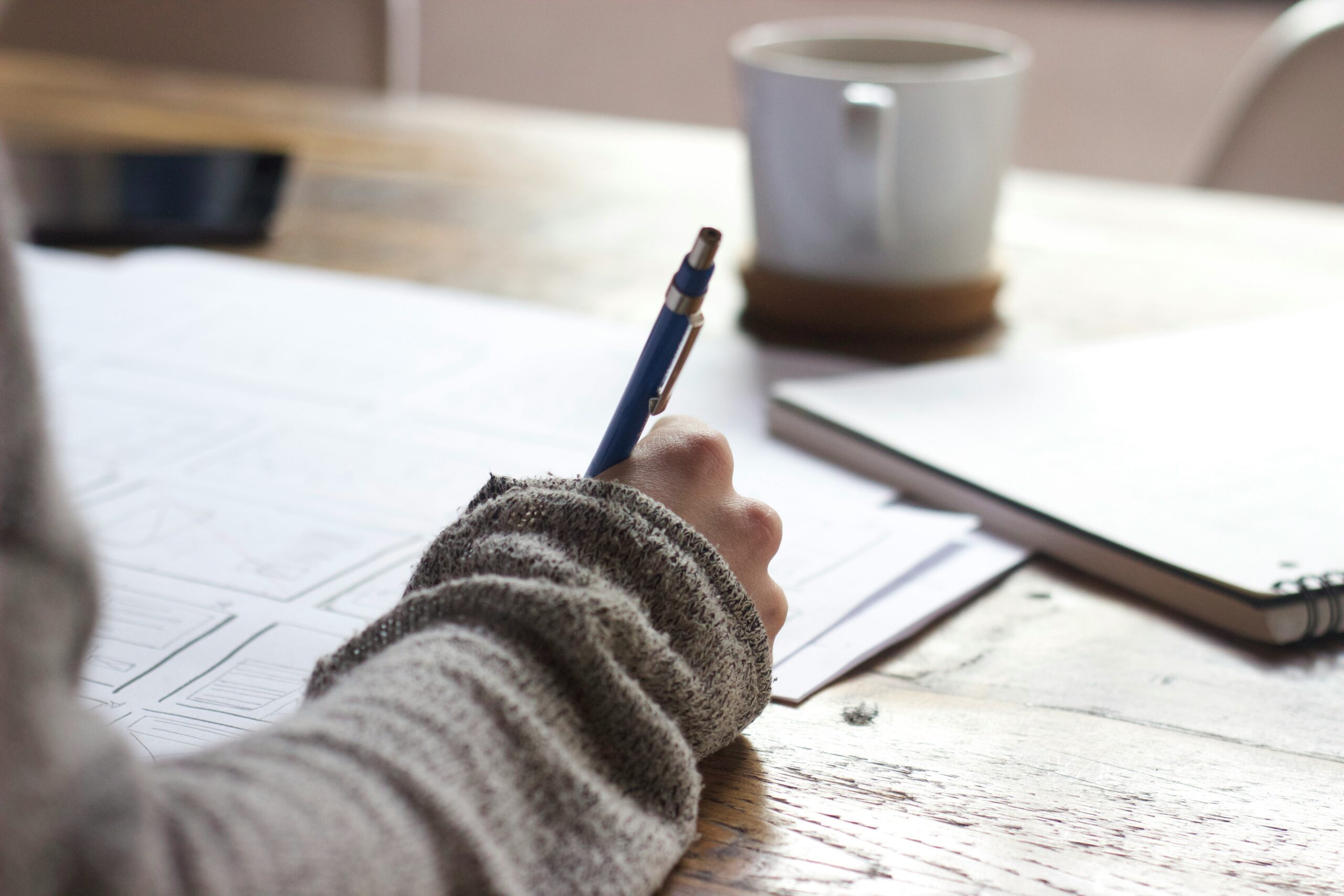 Writing at a desk with a coffee